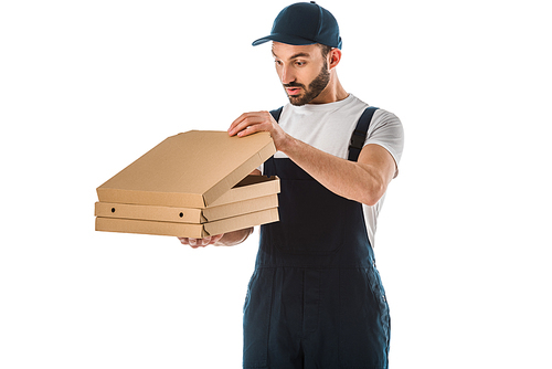 surprised delivery man in overalls looking into pizza box isolated on white