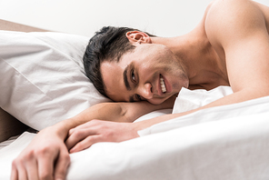 low angle view of happy man  while lying on bed