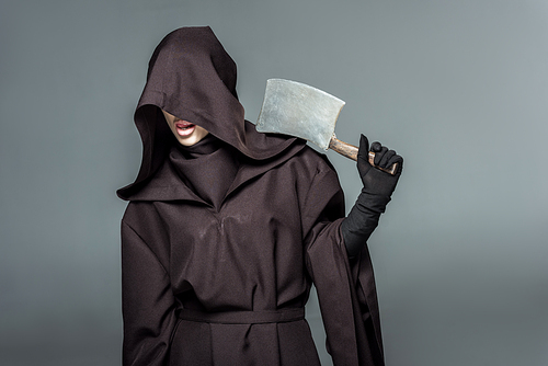 woman in death costume holding cleaver isolated on grey