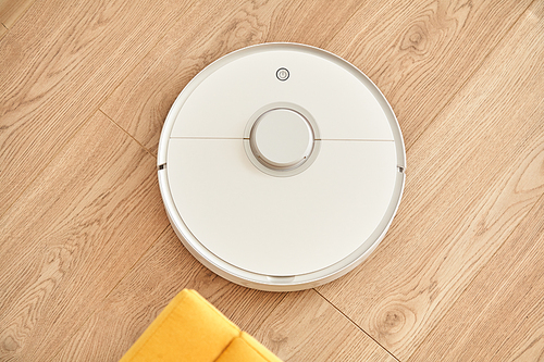 top view of white robotic vacuum cleaner washing floor