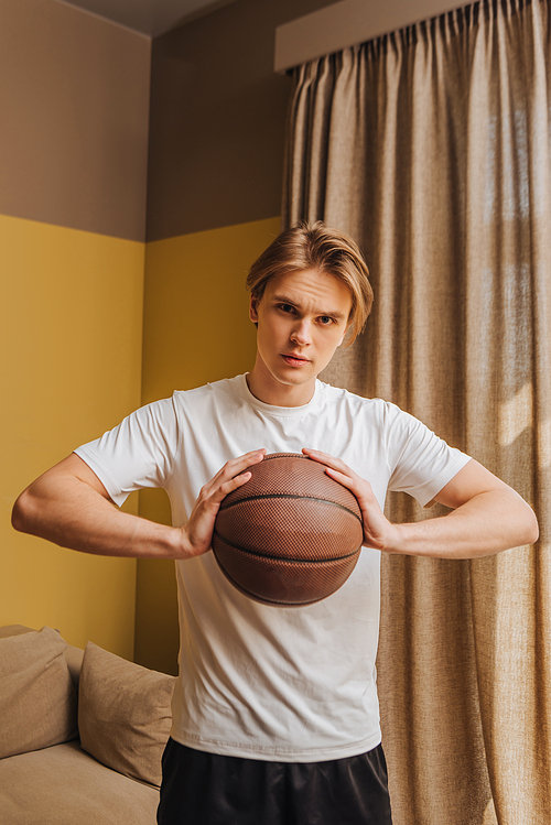young and handsome man  while holding basketball, end of quarantine concept