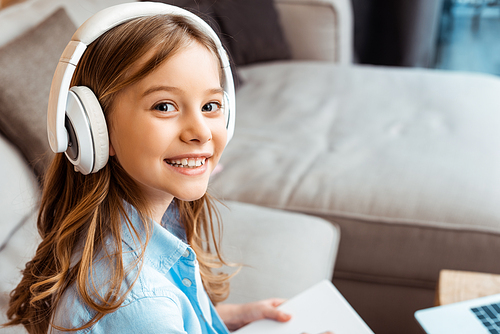 happy kid in wireless headphones 