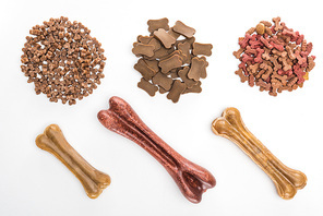 top view of assorted dry pet food and bones isolated on white