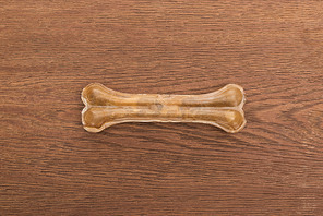 top view of pet bone on wooden table