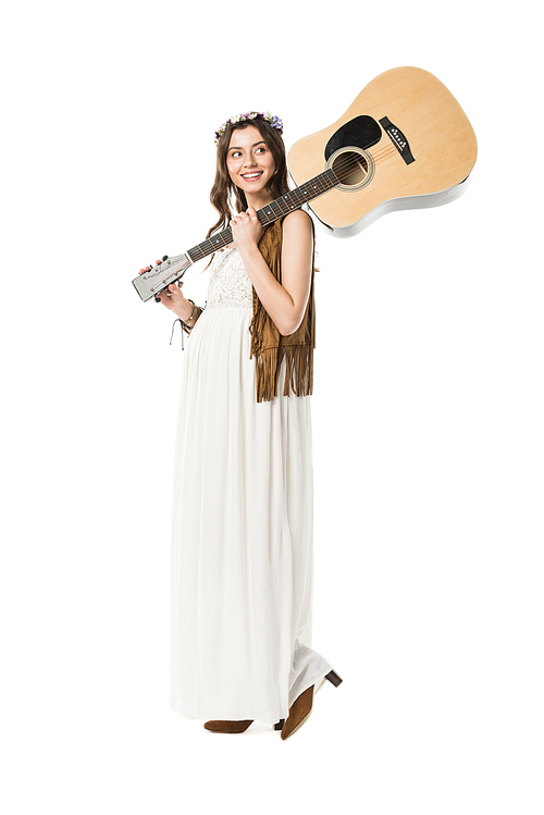 full length view of smiling pregnant hippie woman holding acoustic guitar isolated on white