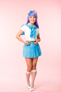 Full length view of pretty anime girl in wig and sailor suit standing on pink