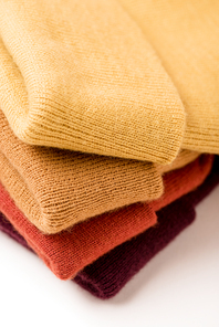 stack of folded colorful clothes on white surface