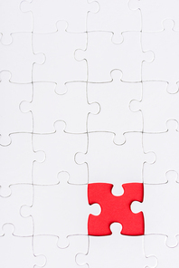top view of white connected puzzles with red shape