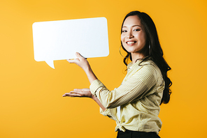 beautiful smiling asian girl presenting speech bubble, isolated on yellow