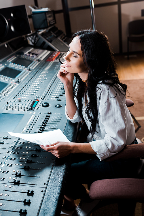 beautiful dreamy sound producer working in recording studio at mixing console