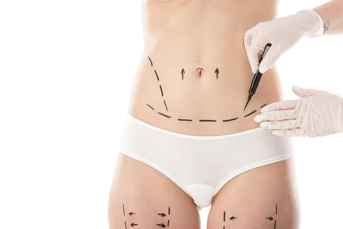 partial view of plastic surgeon in latex gloves making marks on body isolated on white