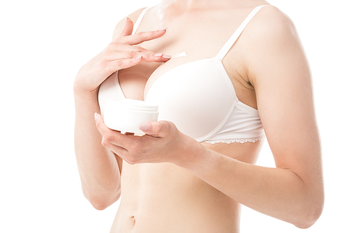 cropped view of young woman in underwear applying cosmetic cream on breast isolated on white