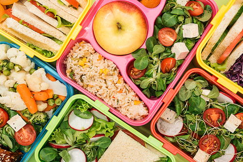 close up view of colorful lunch boxes with food