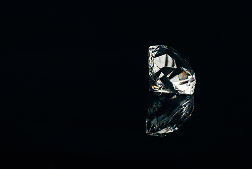 transparent pure diamond isolated on black with reflection