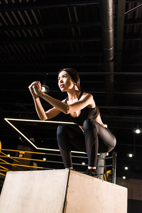 low angle view of attractive woman doing  exercise on  box