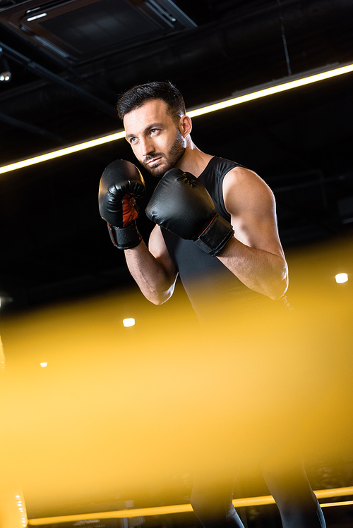 selective focus of confident man boxing in sports center