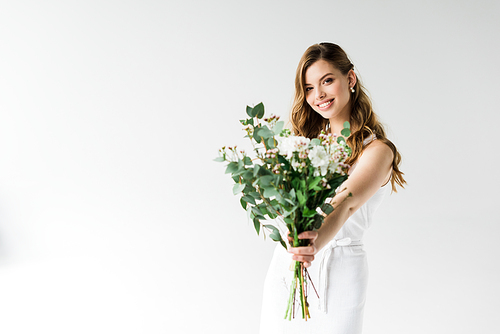 selective focus of cheerful girl holding bouquet of flowers on white