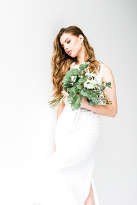 elegant girl in dress holding bouquet of flowers on white