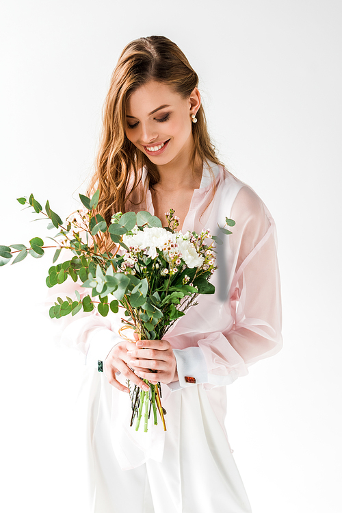 smiling girl holding flowers with green eucalyptus leaves on white