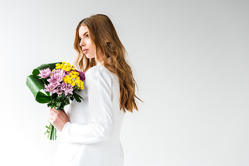 dreamy girl holding bouquet of wildflowers on white