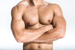 cropped view of athletic man with muscular torso posing on white