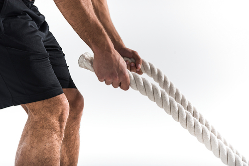 cropped view of sportive man holding white ropes on white background