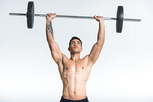 handsome sportive mixed race man lifting barbell on white background