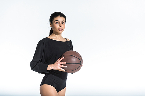 beautiful african american girl in black sportswear holding ball and  on white