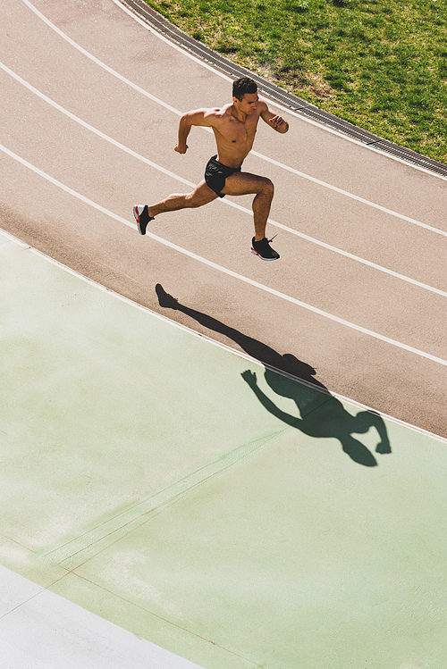 overhead view of mixed race sportsman running at stadium