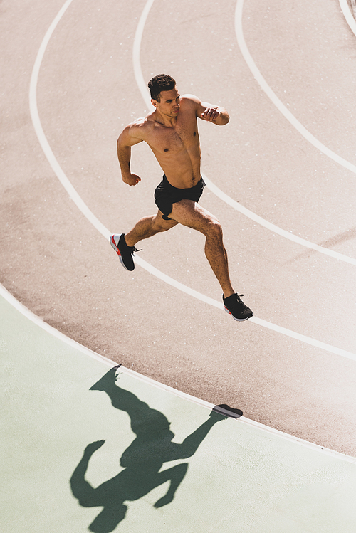 overhead view of mixed race sportsman running at stadium