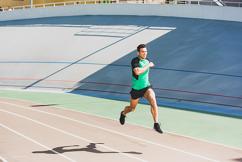 full length view of mixed race sportsman running at stadium