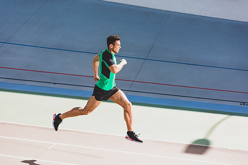 full length view of mixed race sportsman running at stadium