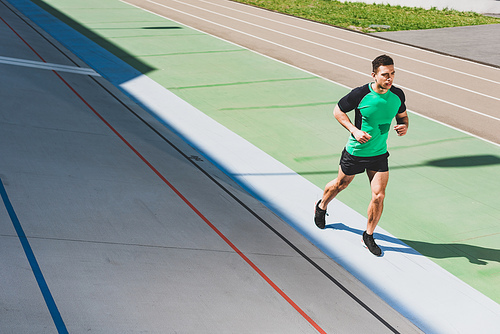 full length view of mixed race sportsman running at stadium