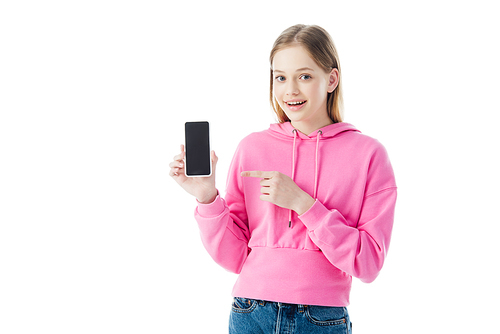 happy teenage girl in pink hoodie pointing with finger at smartphone isolated on white