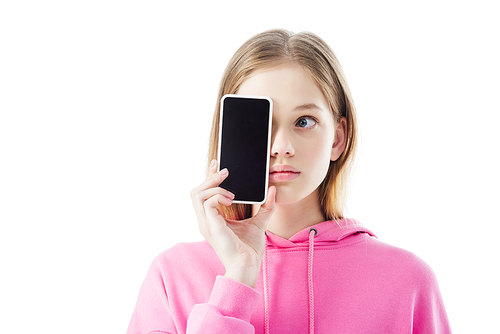 teenage girl in pink hoodie holding smartphone with blank screen in front of face isolated on white