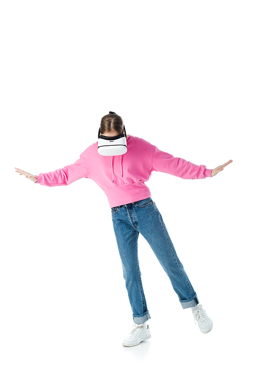 teenage girl in pink hoodie and blue jeans wearing vr headset and gesturing isolated on white