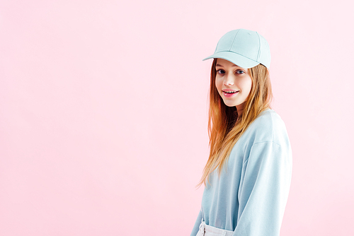 happy pretty teenage girl in cap  isolated on pink