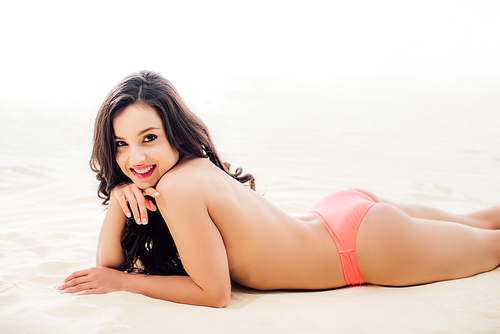 beautiful topless Young woman , smiling and relaxing on sandy beach