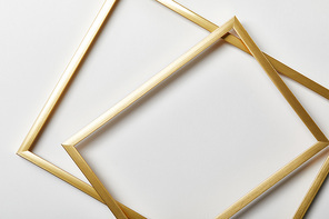 top view of golden frames on white background with copy space