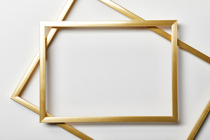 top view of empty golden frames on white background with copy space