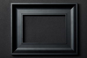 top view of empty black frame on black background with copy space