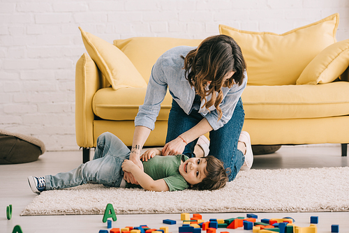 Mother and son playing together in living room