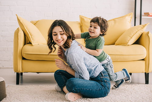 Mother and son playing together in living room