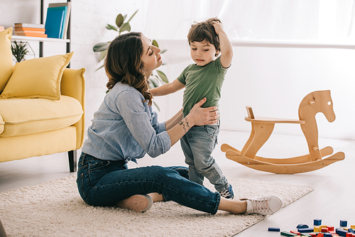 Mother and son playing together in living room