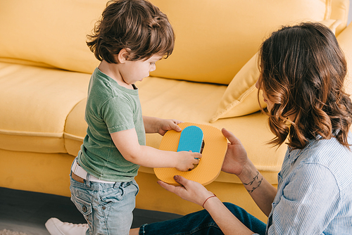 mother and little son learning alphabet in living room