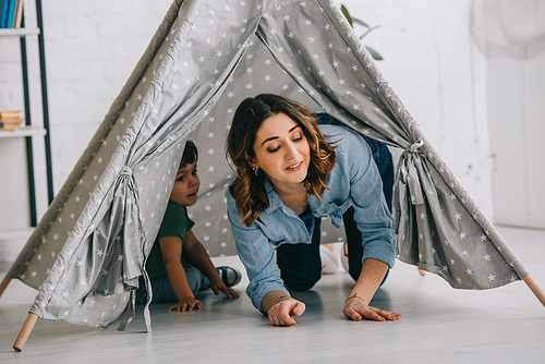 Mother and son in grey wigwam in living room