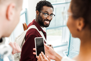 smiling african american student in glasses  with smile