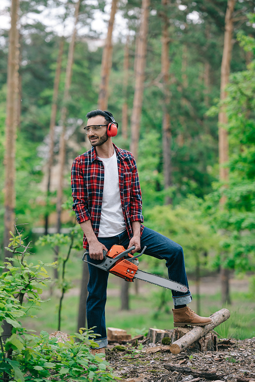 유토이미지 | smiling lumberman in plaid shirt and denim jeans standing with ...