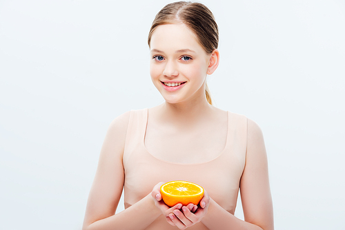 teenage girl with smile holding ripe orange half isolated on grey