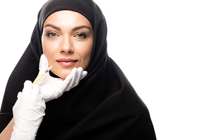 young Muslim woman in hijab having beauty injection isolated on white, lip augmentation concept